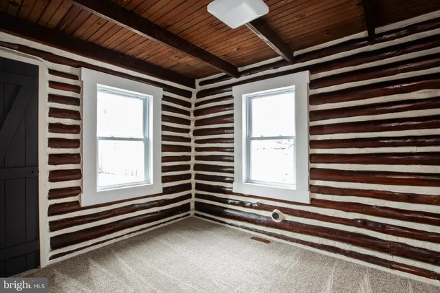 a view of an empty room with a windows