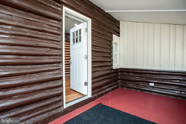 a view of room with stairs and a rug