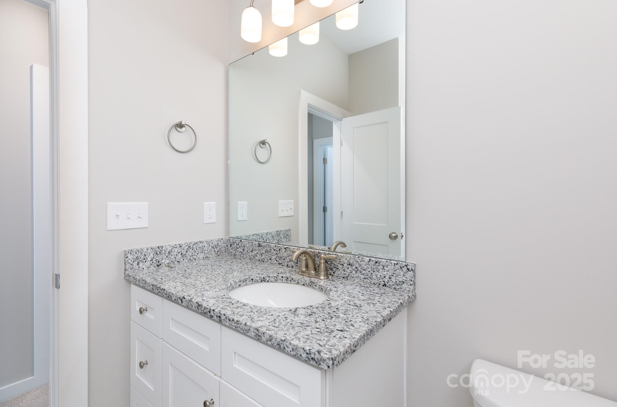 3339 Lesslie Highway, Unit 2 Rock Hill, SC 29730 - Photo 17 of 42 a bathroom with a granite countertop sink and a mirror
