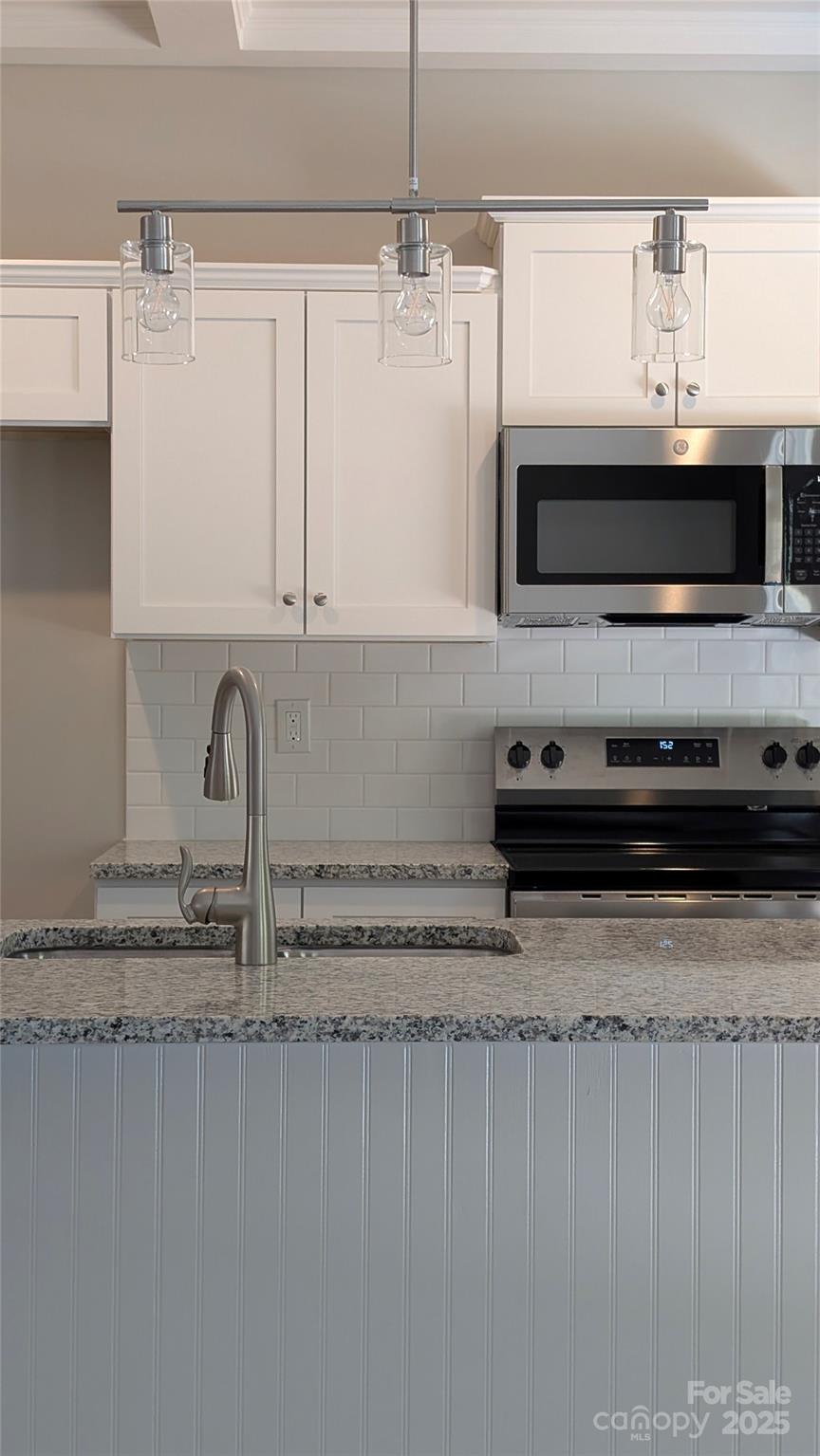 3339 Lesslie Highway, Unit 2 Rock Hill, SC 29730 - Photo 40 of 42 a kitchen with stainless steel appliances granite countertop a sink a stove and a microwave