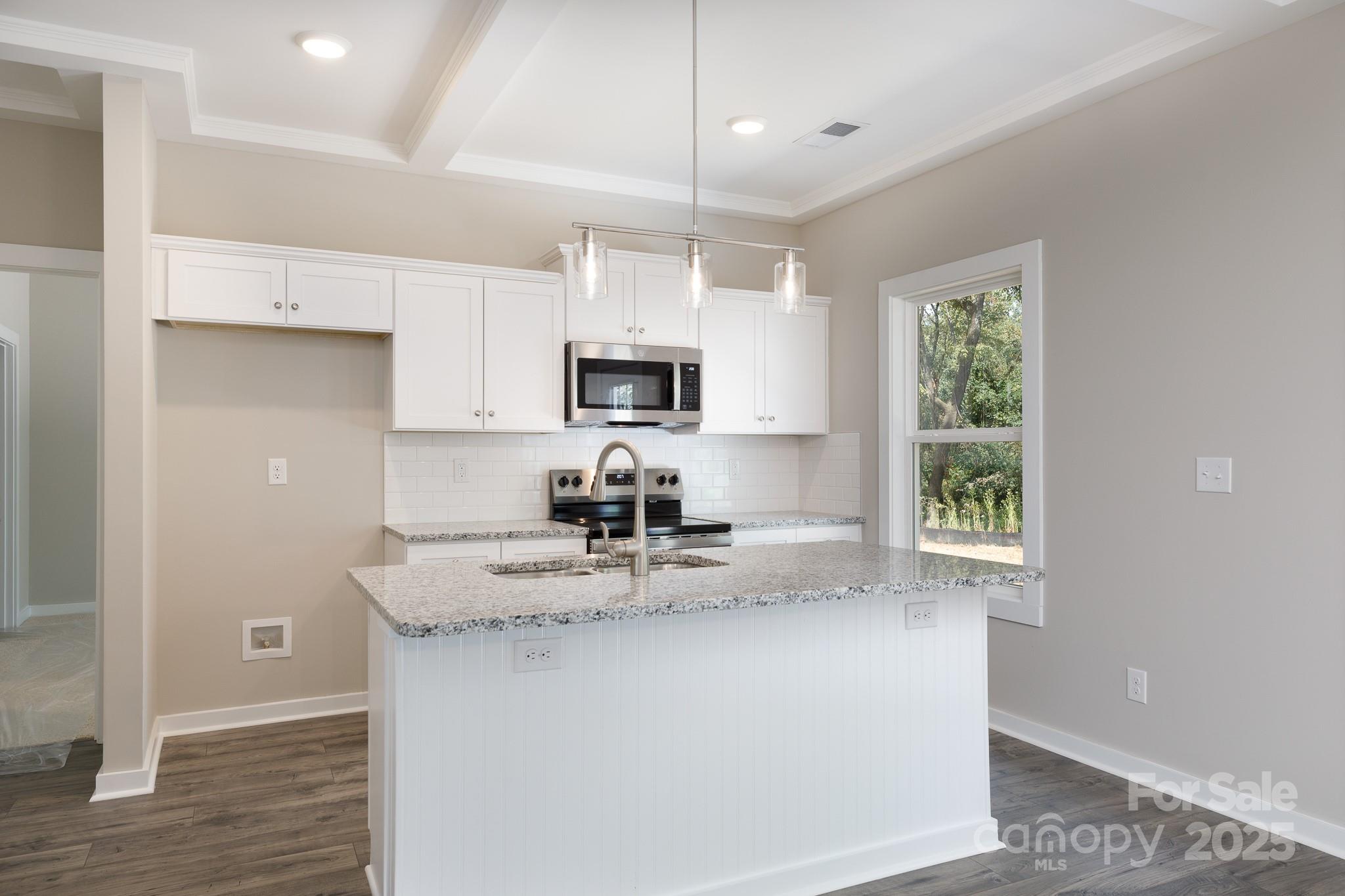 3339 Lesslie Highway, Unit 2 Rock Hill, SC 29730 - Photo 7 of 42 a kitchen with kitchen island granite countertop a sink window and cabinets