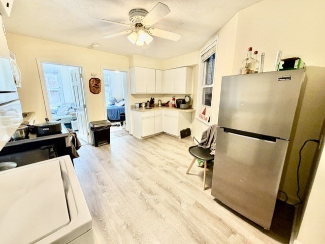 14 Cleveland Place, Unit 2 Boston, MA 02113 - Photo 6 of 18 a kitchen with stainless steel appliances a refrigerator a stove a sink dishwasher and white countertops with wooden floor