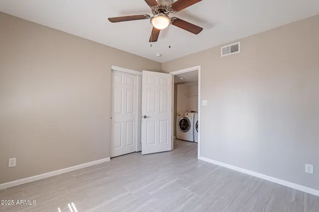 a view of a big room with wooden floor and windows