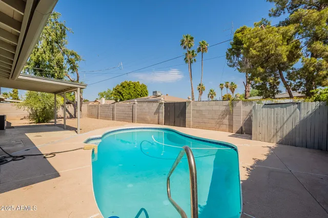 a small pool with lawn chairs