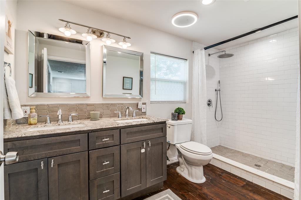 113 Caddo Street Josephine, TX 75173 - Photo 16 of 31 a bathroom with a toilet sink a shower and a mirror