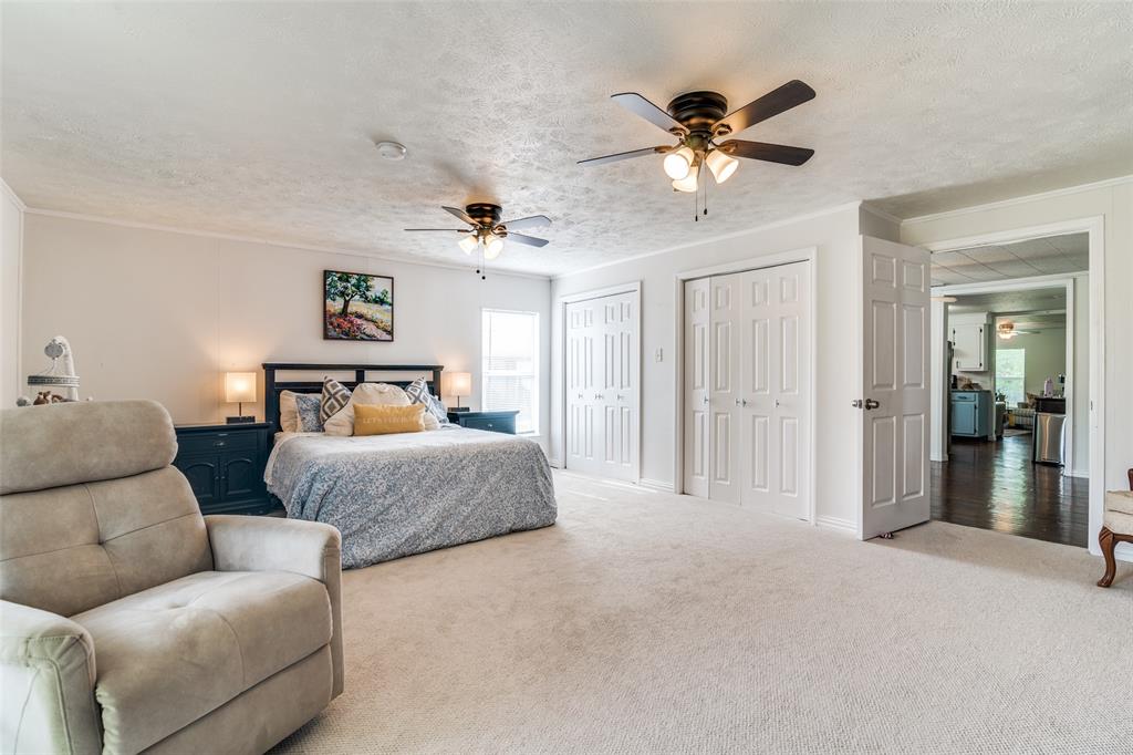113 Caddo Street Josephine, TX 75173 - Photo 18 of 31 a bedroom with furniture and a ceiling fan