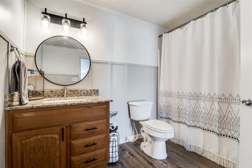 113 Caddo Street Josephine, TX 75173 - Photo 21 of 31 a bathroom with a toilet a sink and a mirror