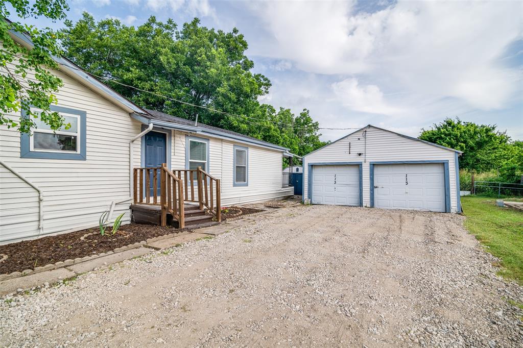 113 Caddo Street Josephine, TX 75173 - Photo 23 of 31 a view of a house with a yard and garage