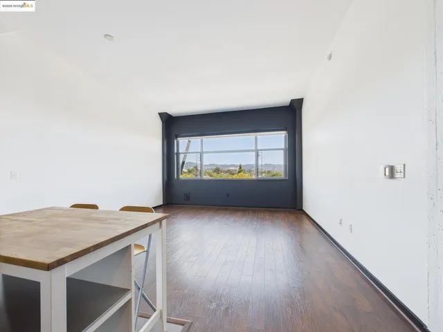 an empty room with wooden floor and cabinet