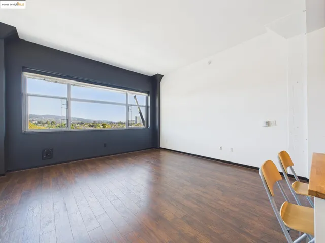 a view of a room with wooden floor and furniture