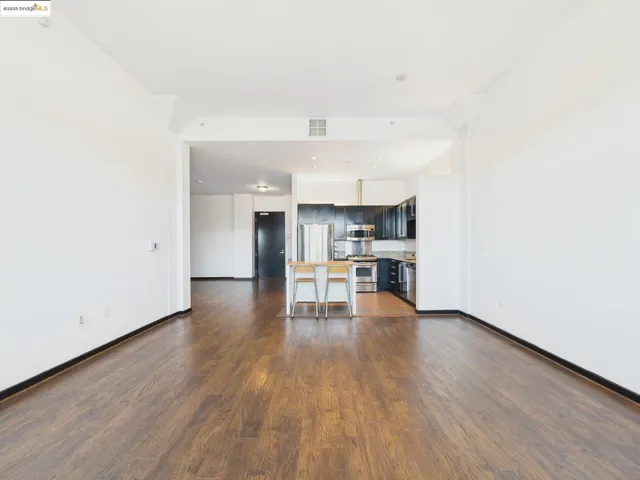 a view of a kitchen with wooden floor and a sink