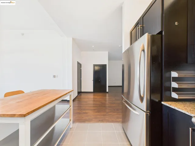 a kitchen with stainless steel appliances granite countertop a refrigerator and a sink