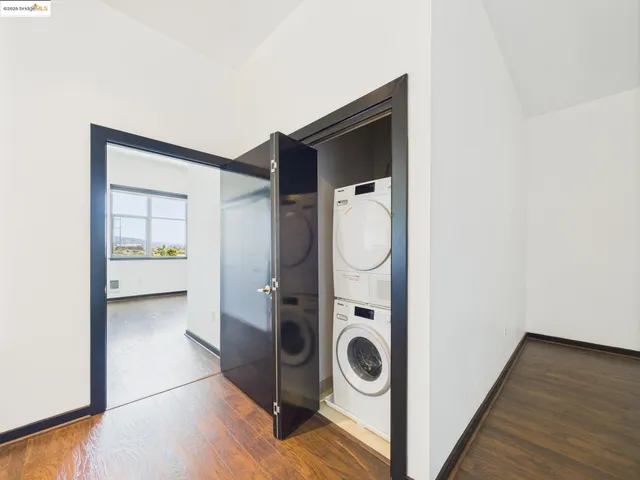 a view of a storage and utility room with wooden floor
