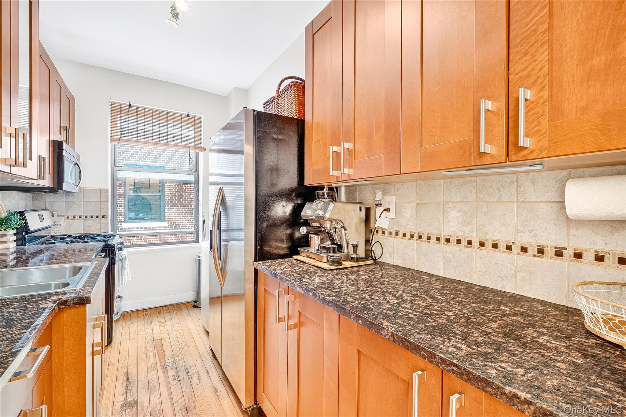 1976 Lafontaine Avenue, Unit 4D Bronx, NY 10457 - Photo 13 of 32 a kitchen with a stove a sink and a refrigerator