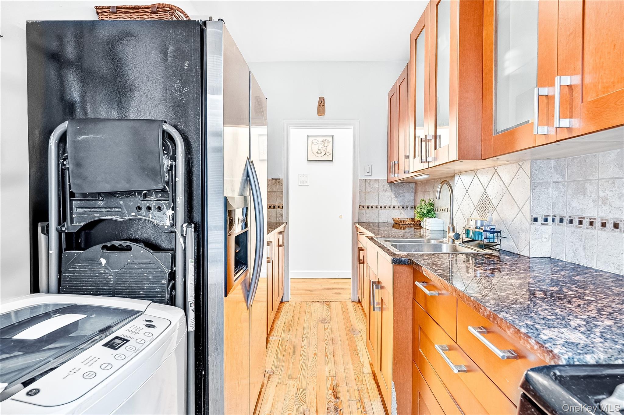 1976 Lafontaine Avenue, Unit 4D Bronx, NY 10457 - Photo 16 of 32 a kitchen with stainless steel appliances granite countertop a refrigerator a stove and a sink with large cabinets