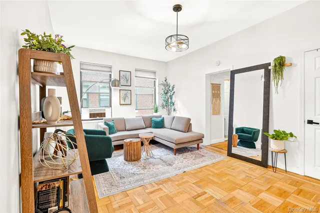 a living room with furniture a rug and a window