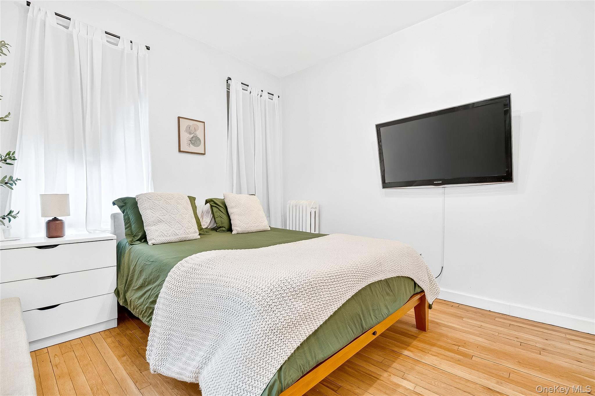 1976 Lafontaine Avenue, Unit 4D Bronx, NY 10457 - Photo 28 of 32 a bedroom with a bed and a flat screen tv