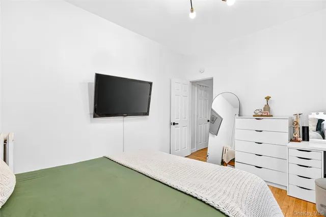 a bedroom with a bed and a mirror