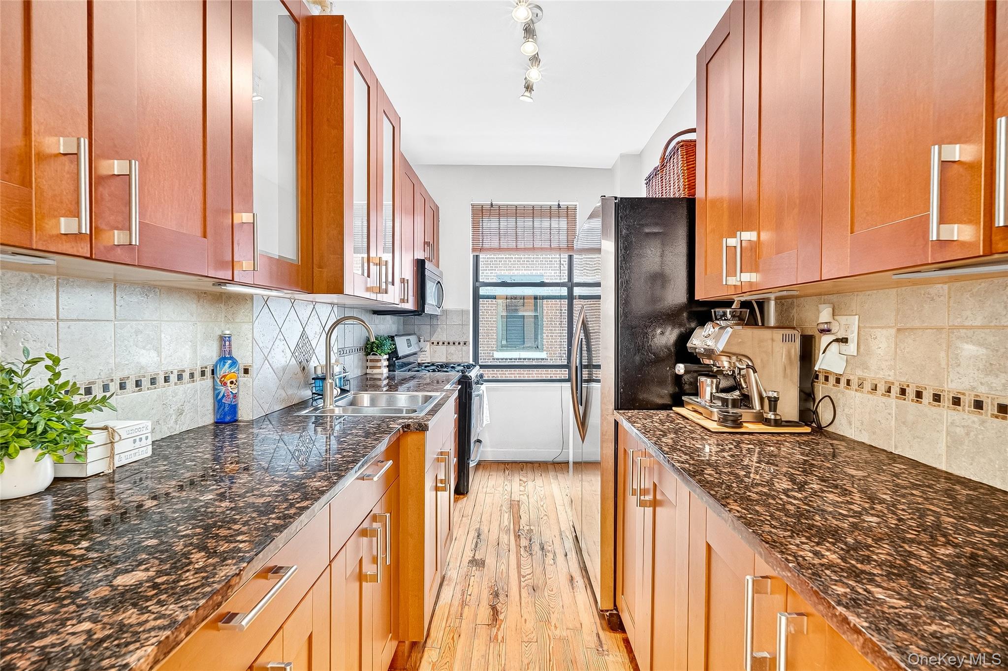 1976 Lafontaine Avenue, Unit 4D Bronx, NY 10457 - Photo 10 of 32 a kitchen with stainless steel appliances granite countertop sink stove refrigerator and cabinets
