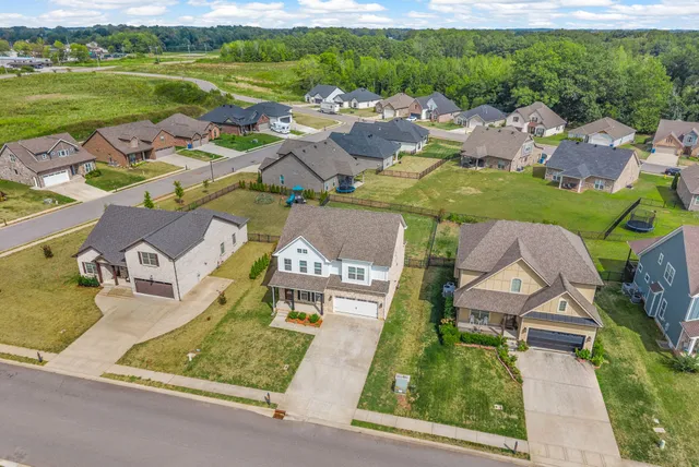 an aerial view of a house with garden space and street view
