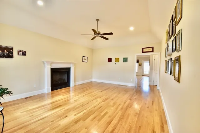 a view of a livingroom with wooden floor and a ceiling fan
