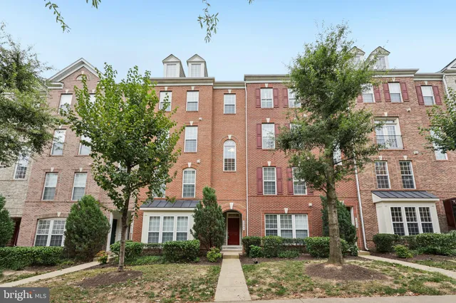a front view of a residential apartment building with a yard