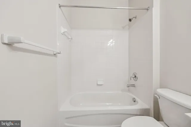 a bathroom with a bathtub and a toilet