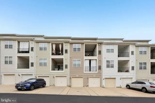 a couple of cars parked in front of a building