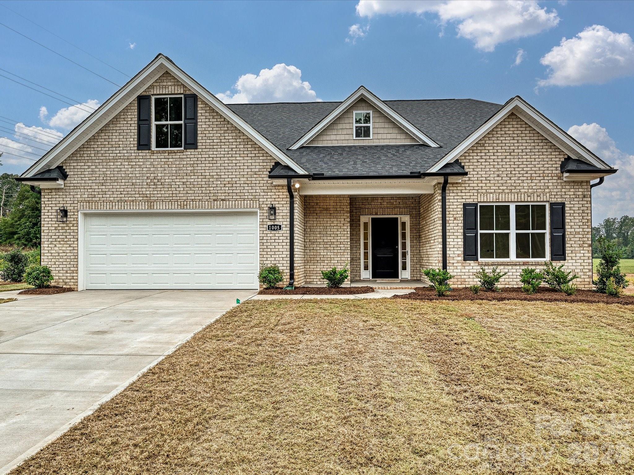 1296 Archer Loop Monroe, NC 28110 - Photo 1 of 39 a front view of a house with a yard and garage