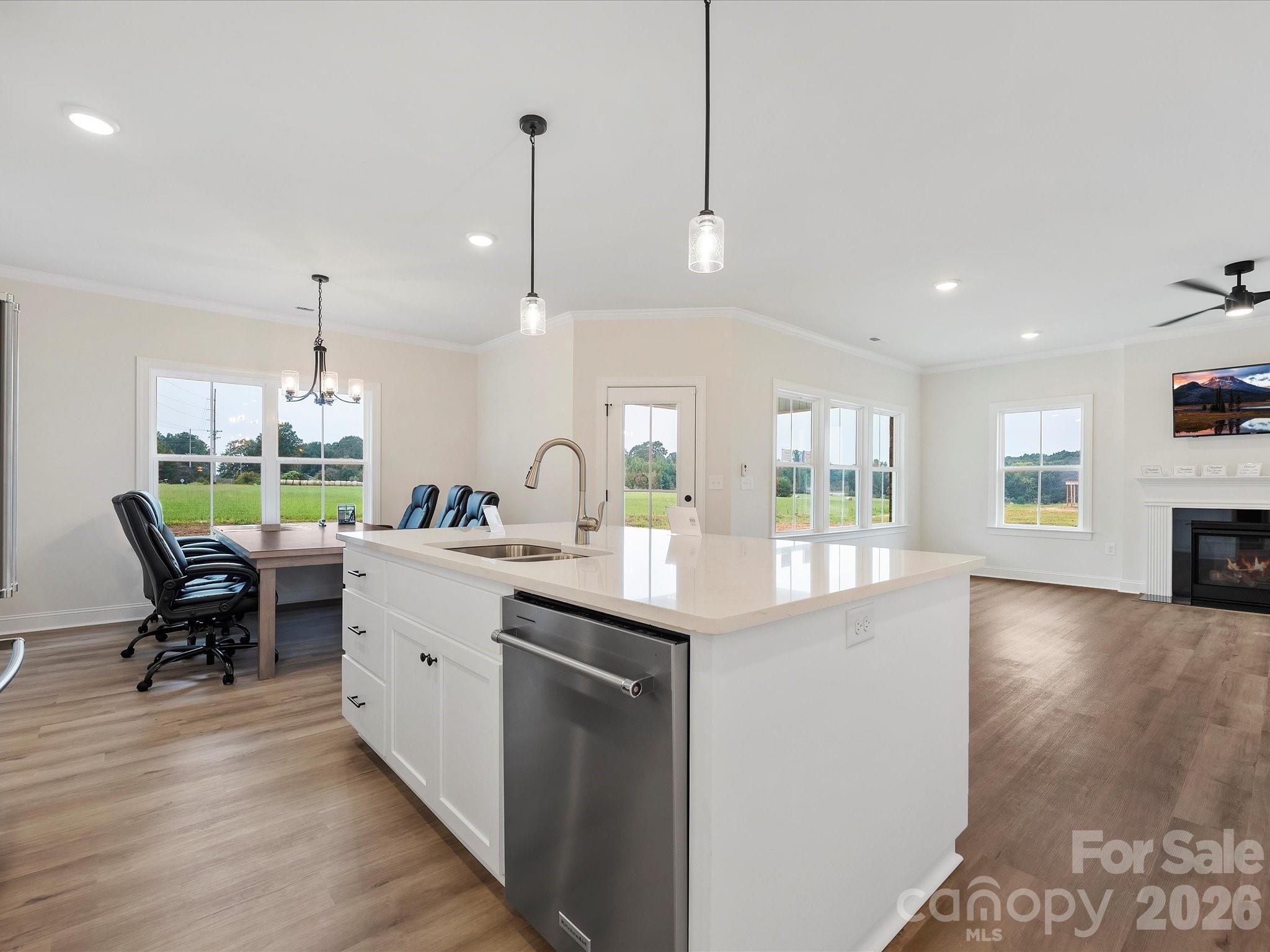 1296 Archer Loop Monroe, NC 28110 - Photo 11 of 39 a kitchen with stainless steel appliances granite countertop a sink a stove and a wooden floors