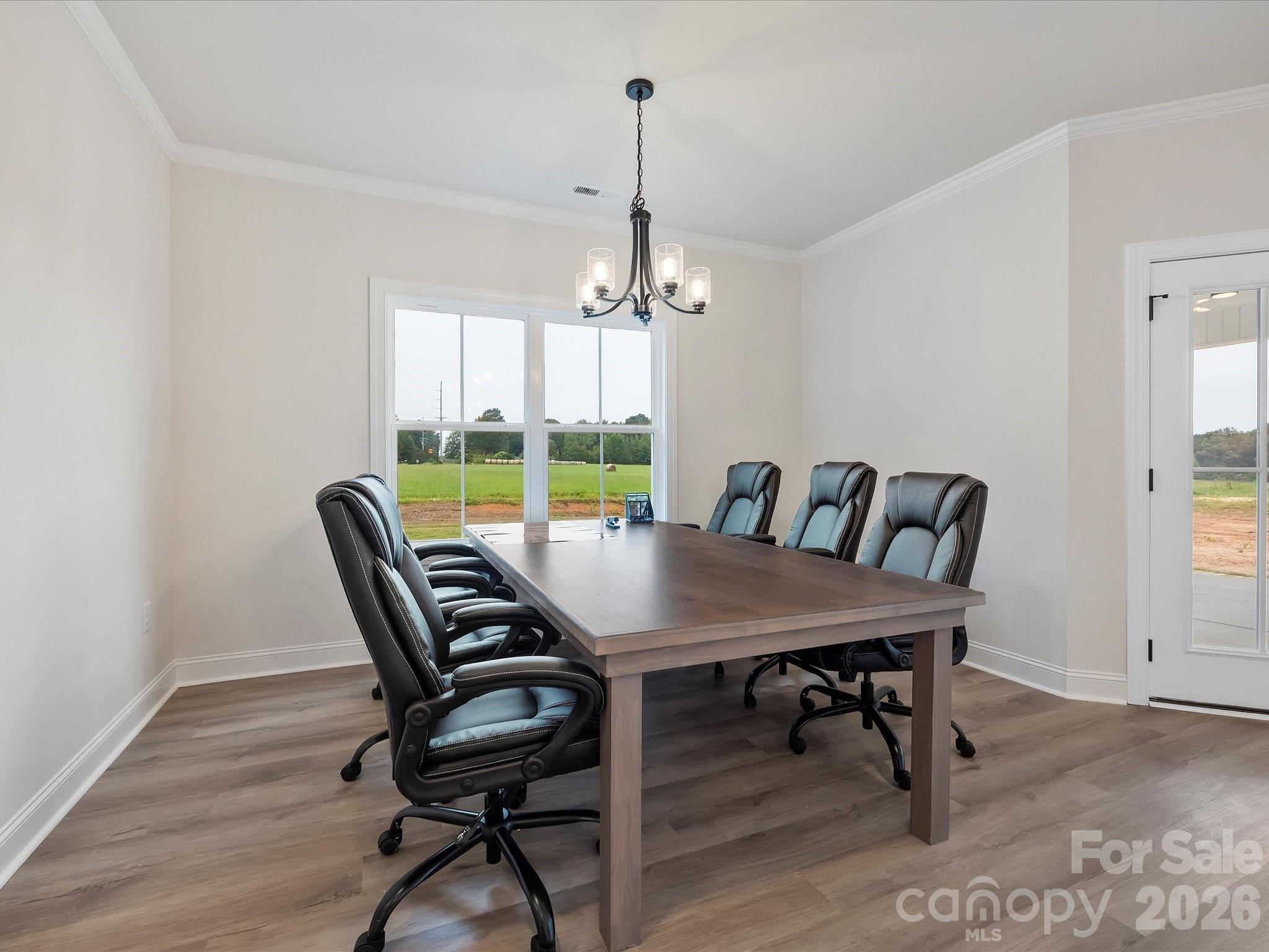 1296 Archer Loop Monroe, NC 28110 - Photo 12 of 39 a view of a dining room with furniture window and wooden floor