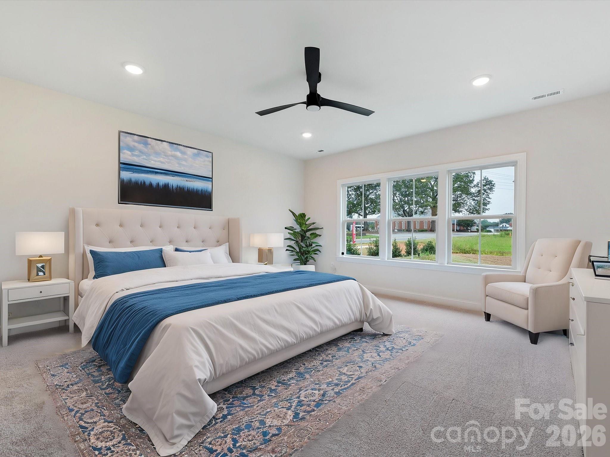 1296 Archer Loop Monroe, NC 28110 - Photo 17 of 39 a bedroom with a large bed and a large window