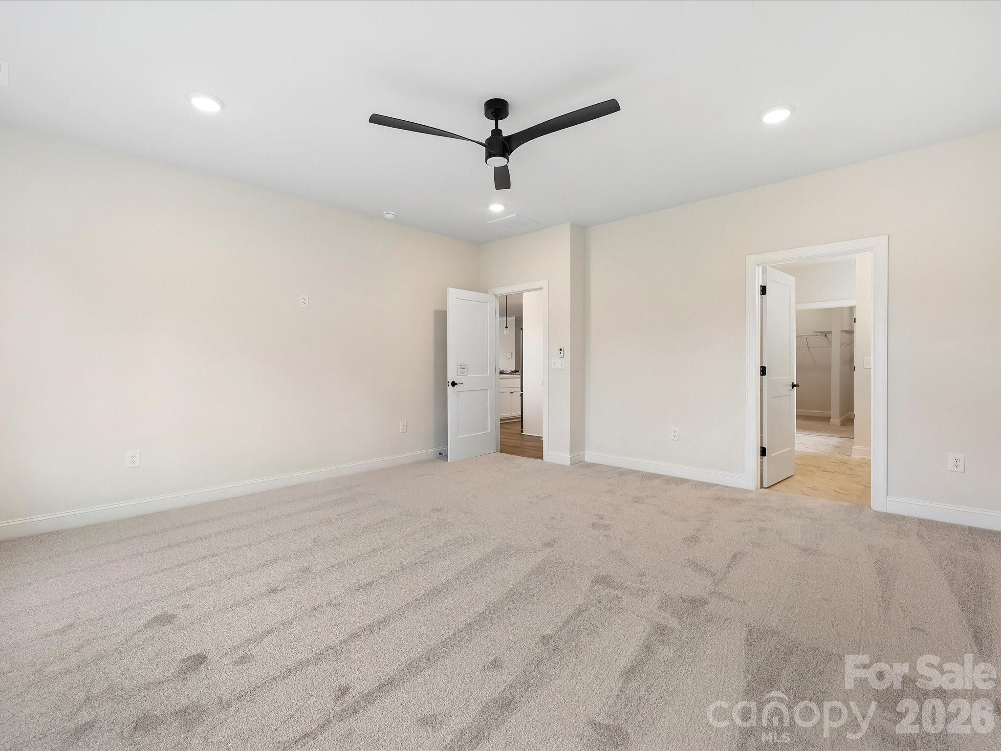 1296 Archer Loop Monroe, NC 28110 - Photo 18 of 39 a view of empty room with wooden floor and ceiling fan