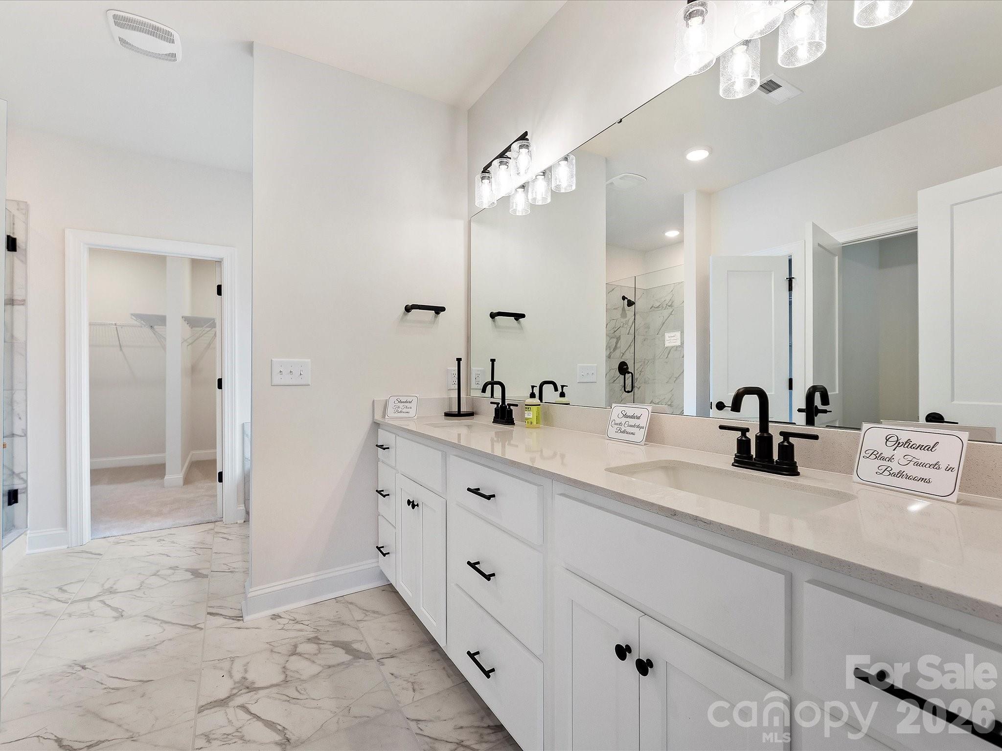 1296 Archer Loop Monroe, NC 28110 - Photo 19 of 39 a bathroom with a double vanity sink mirror and shower