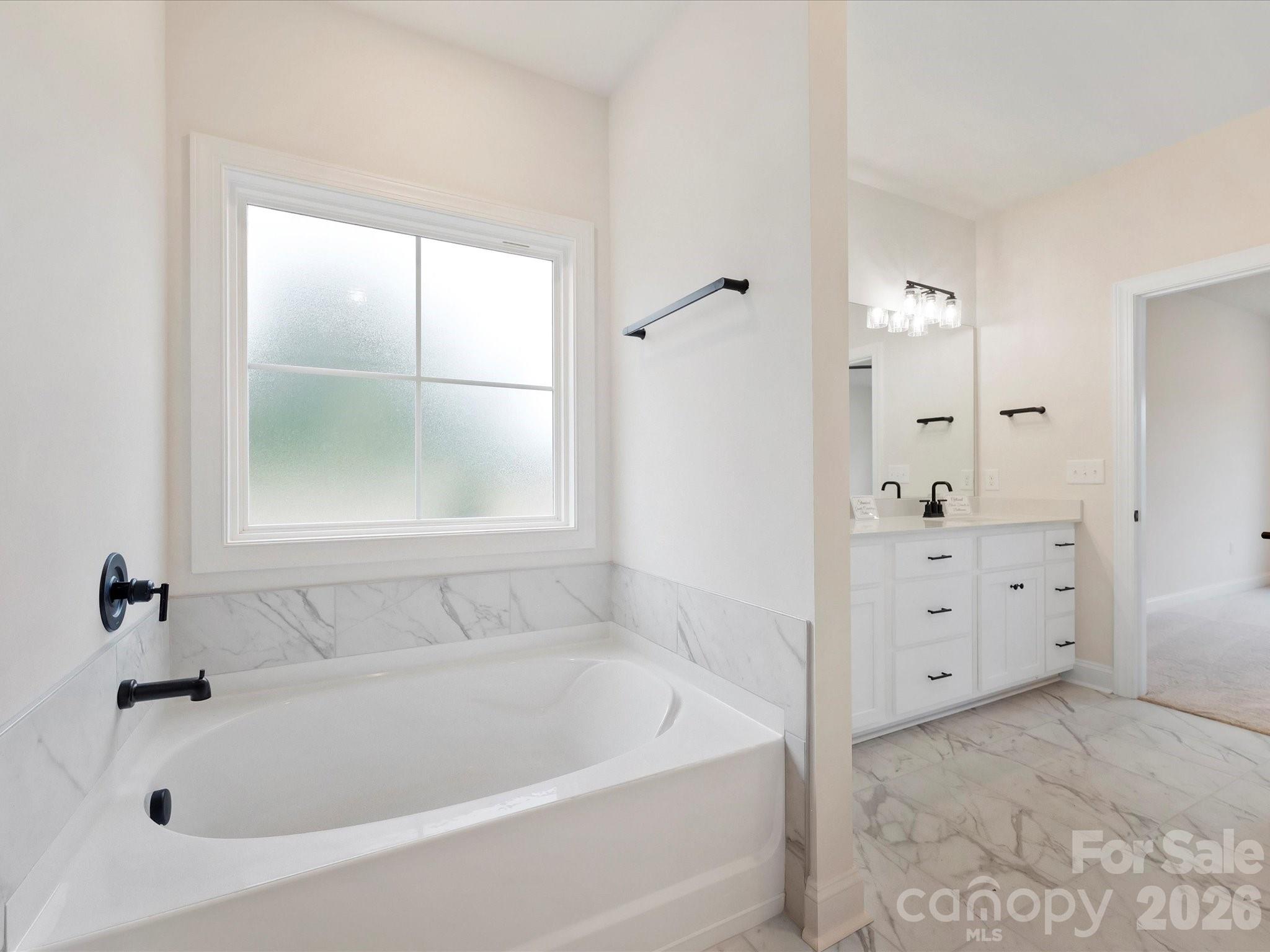 1296 Archer Loop Monroe, NC 28110 - Photo 20 of 39 a bathroom with a bathtub and a window