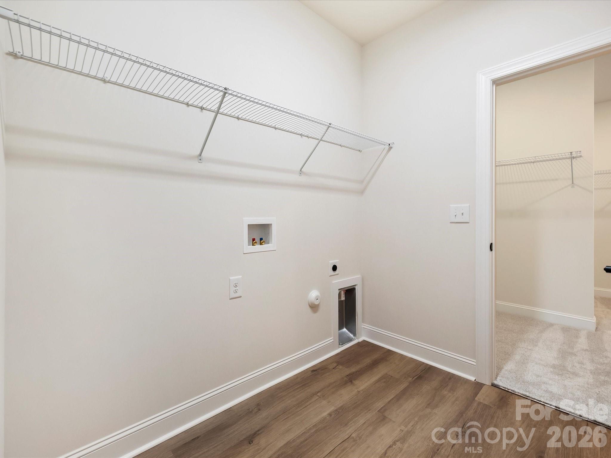 1296 Archer Loop Monroe, NC 28110 - Photo 23 of 39 an empty room with wooden floor and white walls