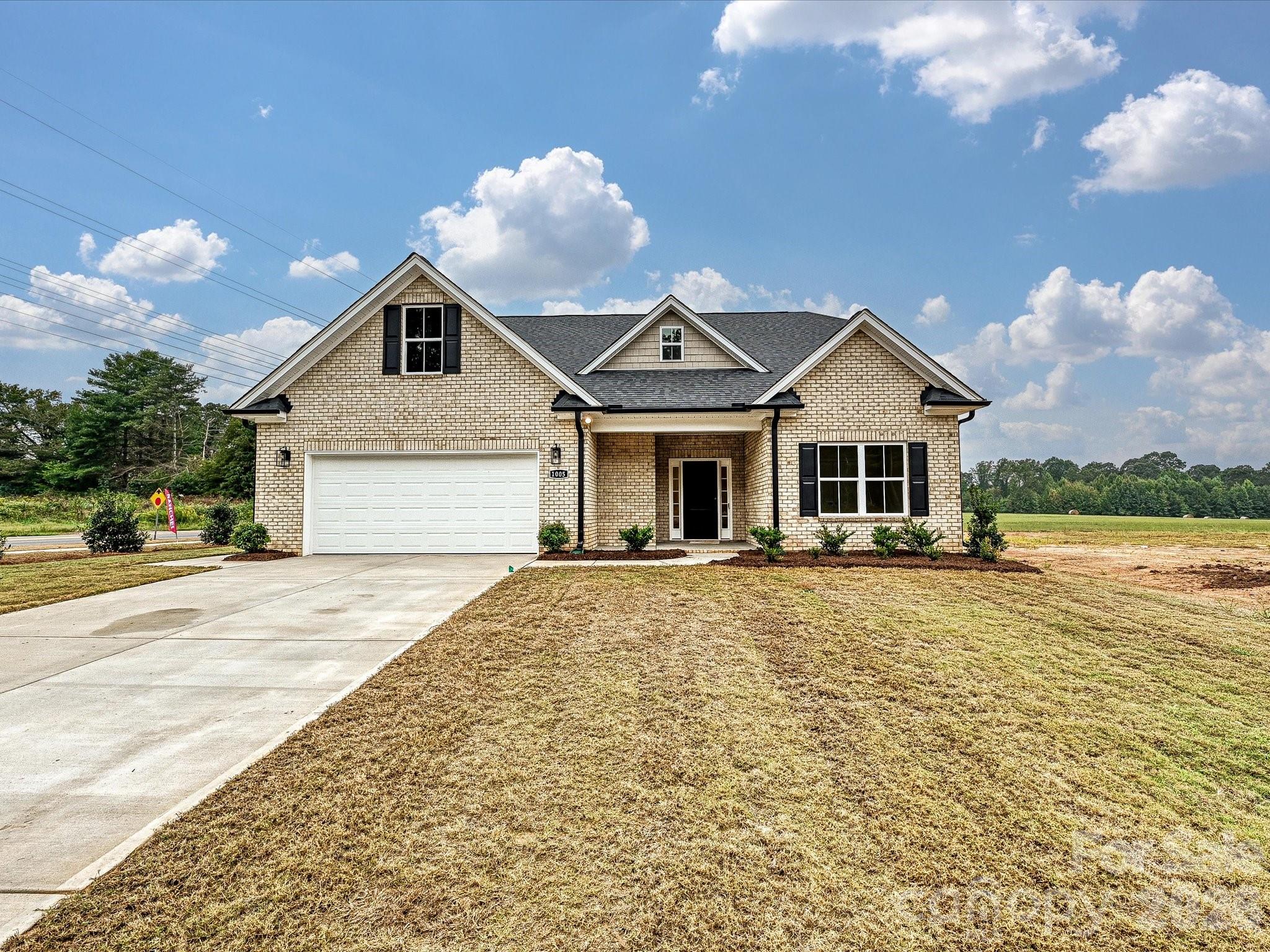 1296 Archer Loop Monroe, NC 28110 - Photo 38 of 39 a front view of a house with a yard and garage