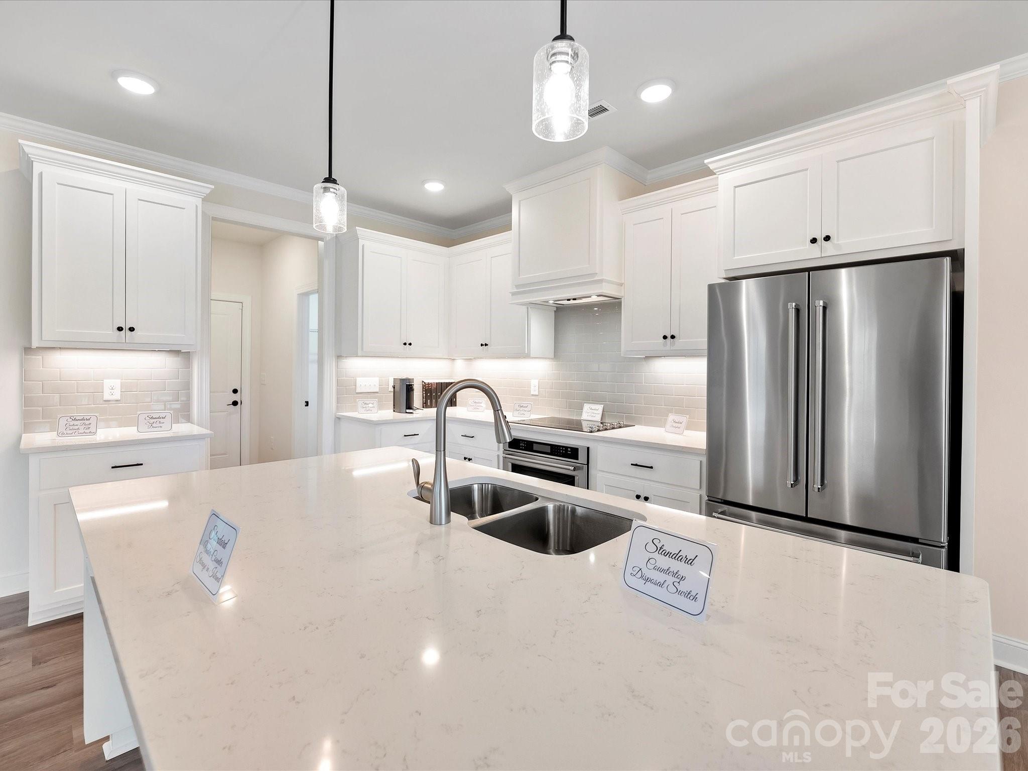1296 Archer Loop Monroe, NC 28110 - Photo 9 of 39 a kitchen with stainless steel appliances a refrigerator sink and microwave