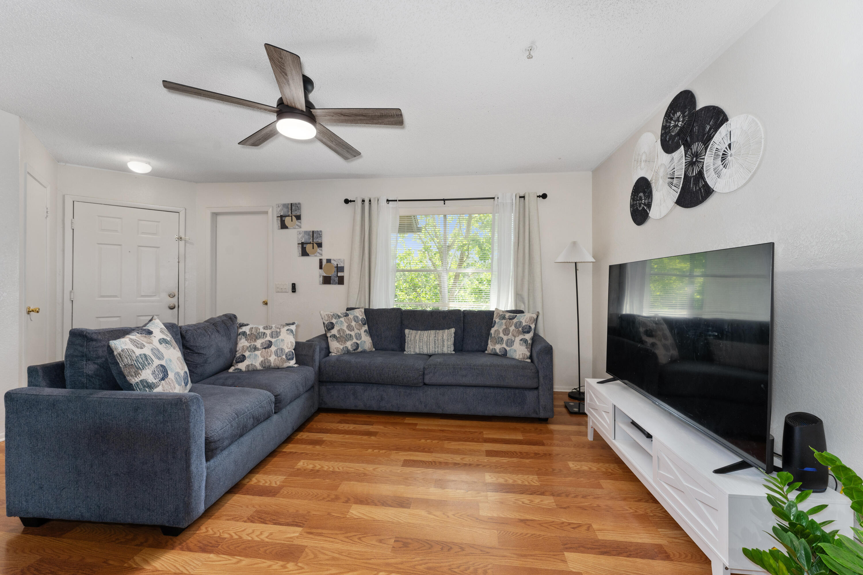 627 Dory Lane, Unit 304 Altamonte Springs, FL 32714 - Photo 2 of 29 a living room with furniture and a flat screen tv