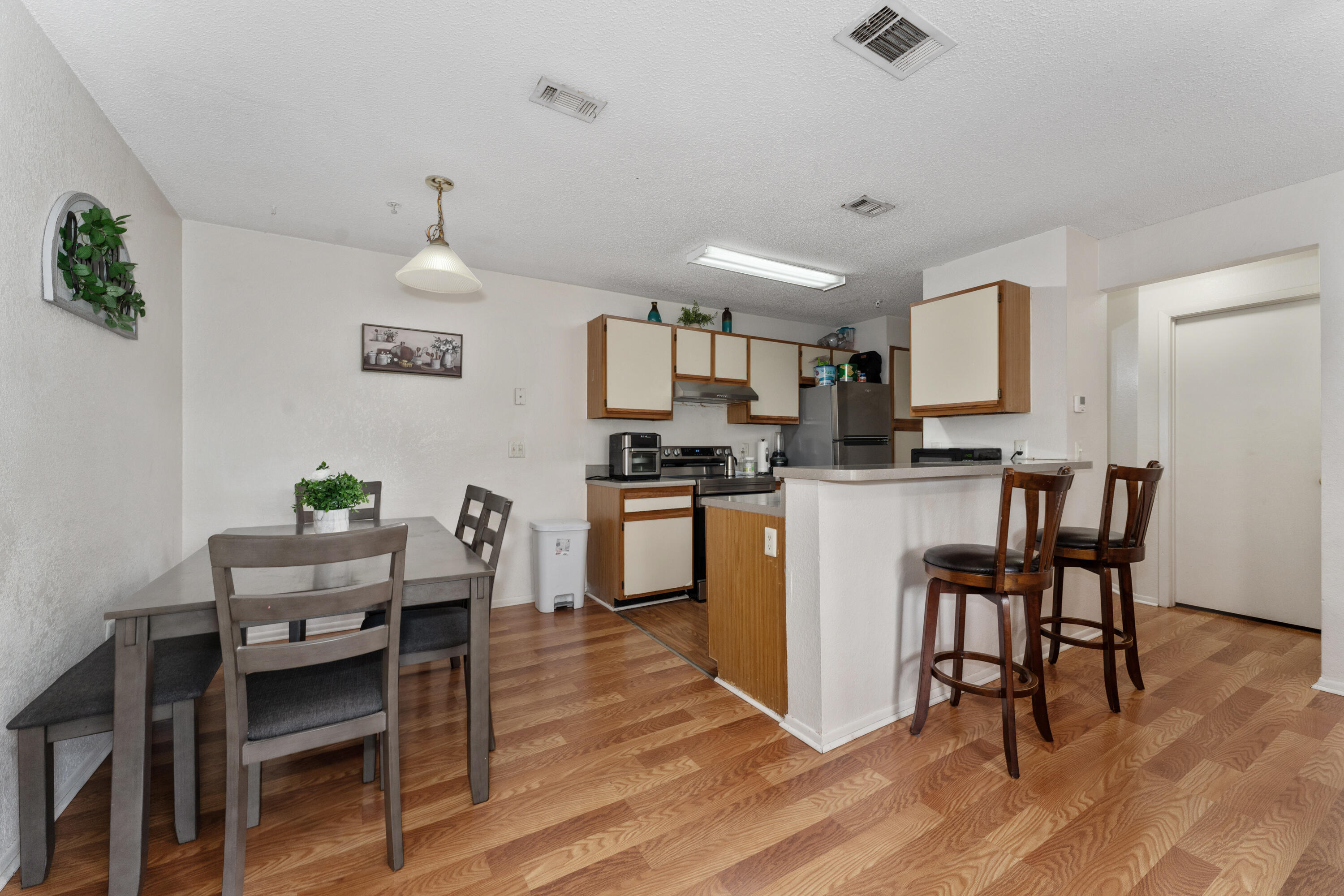 627 Dory Lane, Unit 304 Altamonte Springs, FL 32714 - Photo 5 of 29 a kitchen with a table chairs microwave and cabinets