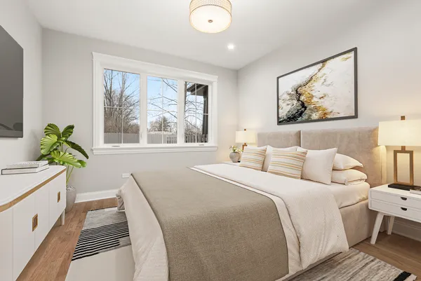 a bedroom with a bed and a large window