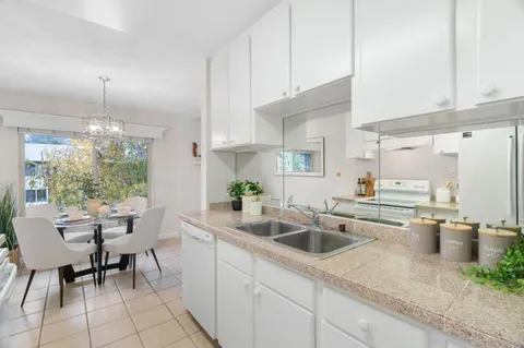 a kitchen with a sink cabinets and window