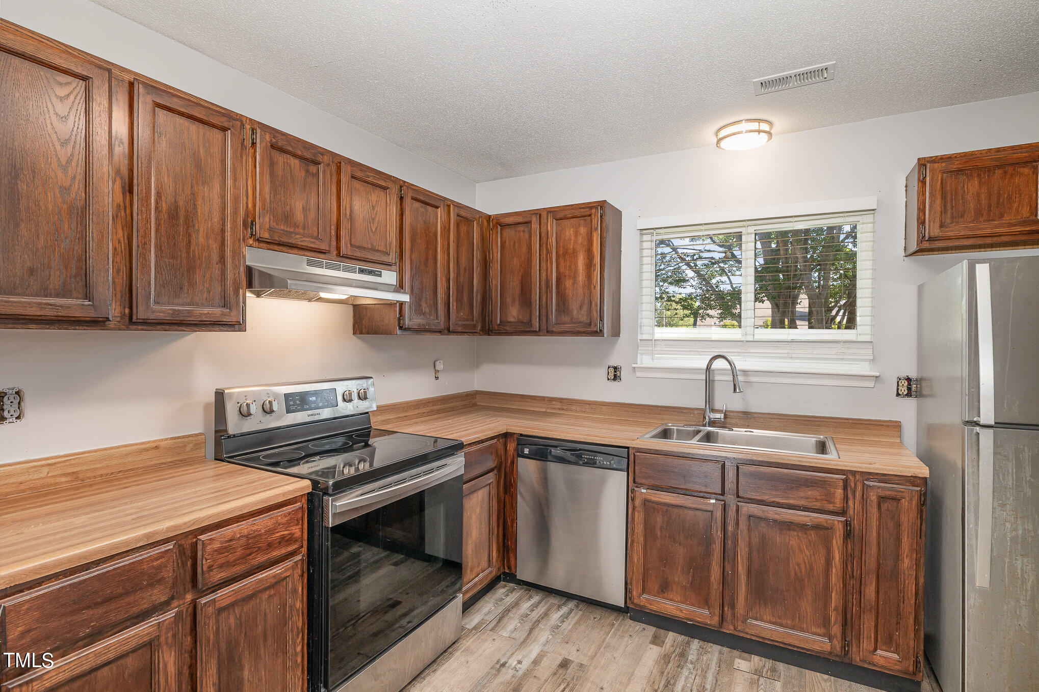 3702 San Pablo Drive Raleigh, NC 27616 - Photo 11 of 26 a kitchen with a sink stove and cabinets