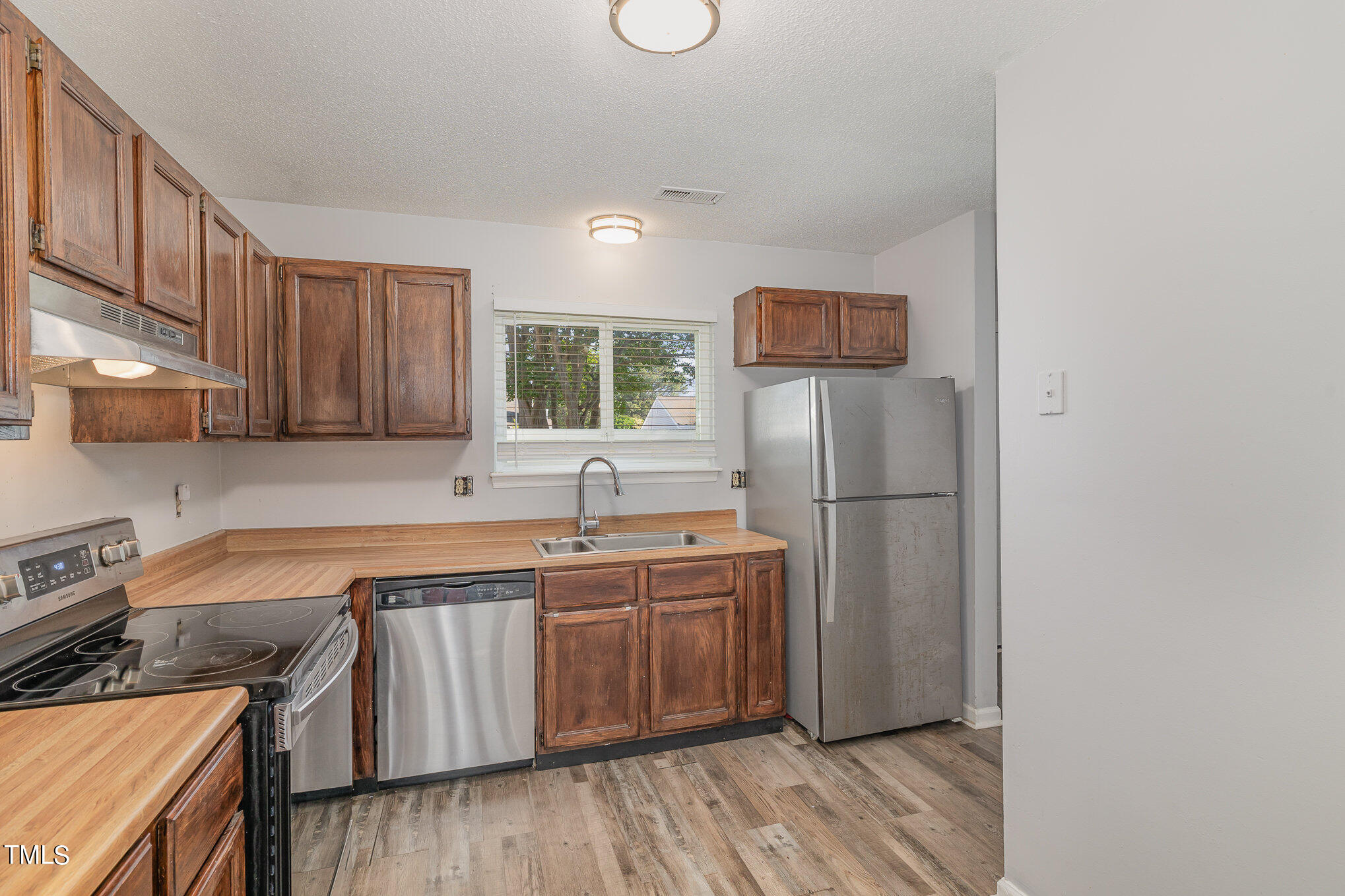 3702 San Pablo Drive Raleigh, NC 27616 - Photo 13 of 26 a kitchen with stainless steel appliances granite countertop a sink stove and refrigerator