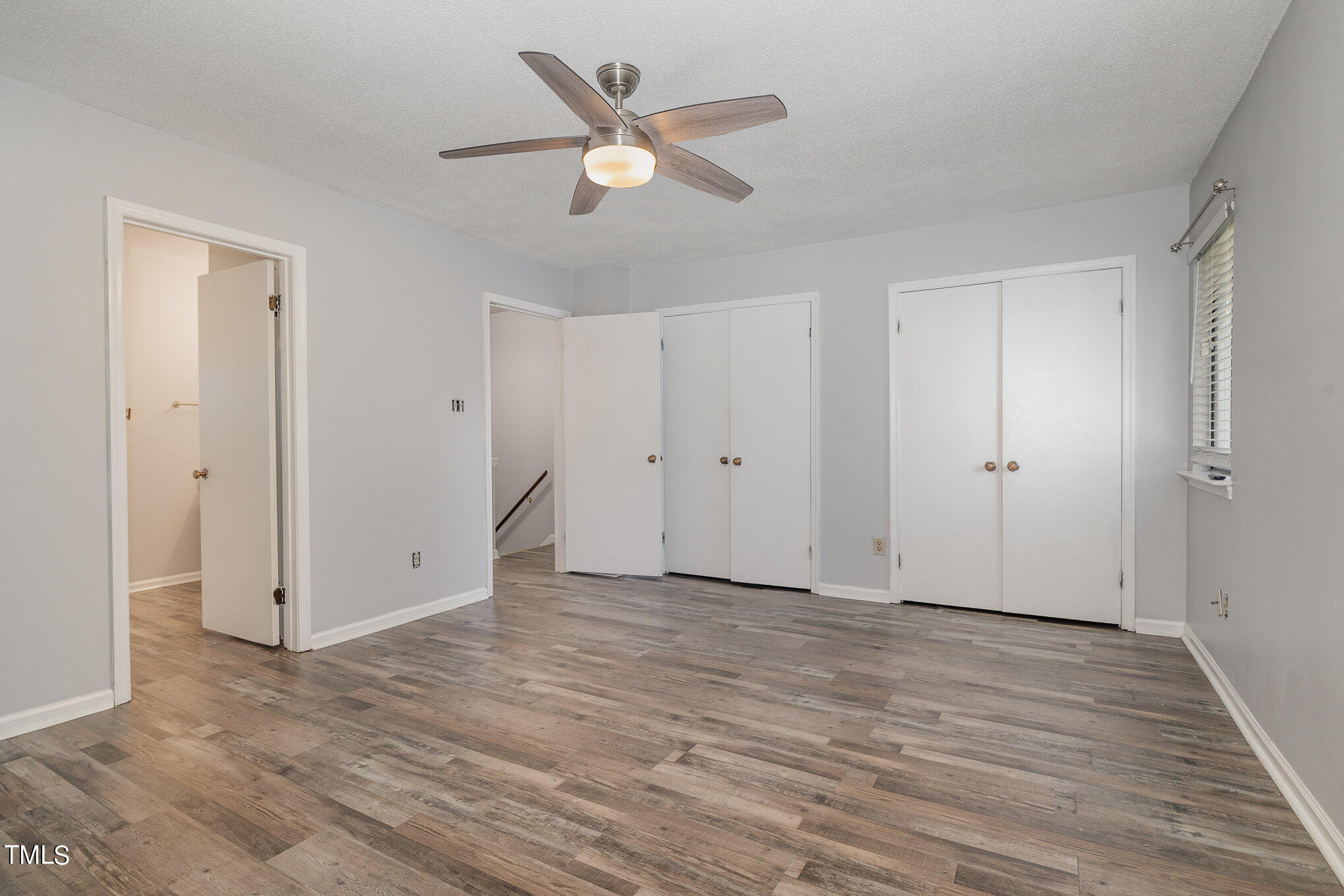 3702 San Pablo Drive Raleigh, NC 27616 - Photo 15 of 26 an empty room with wooden floor ceiling fan and window