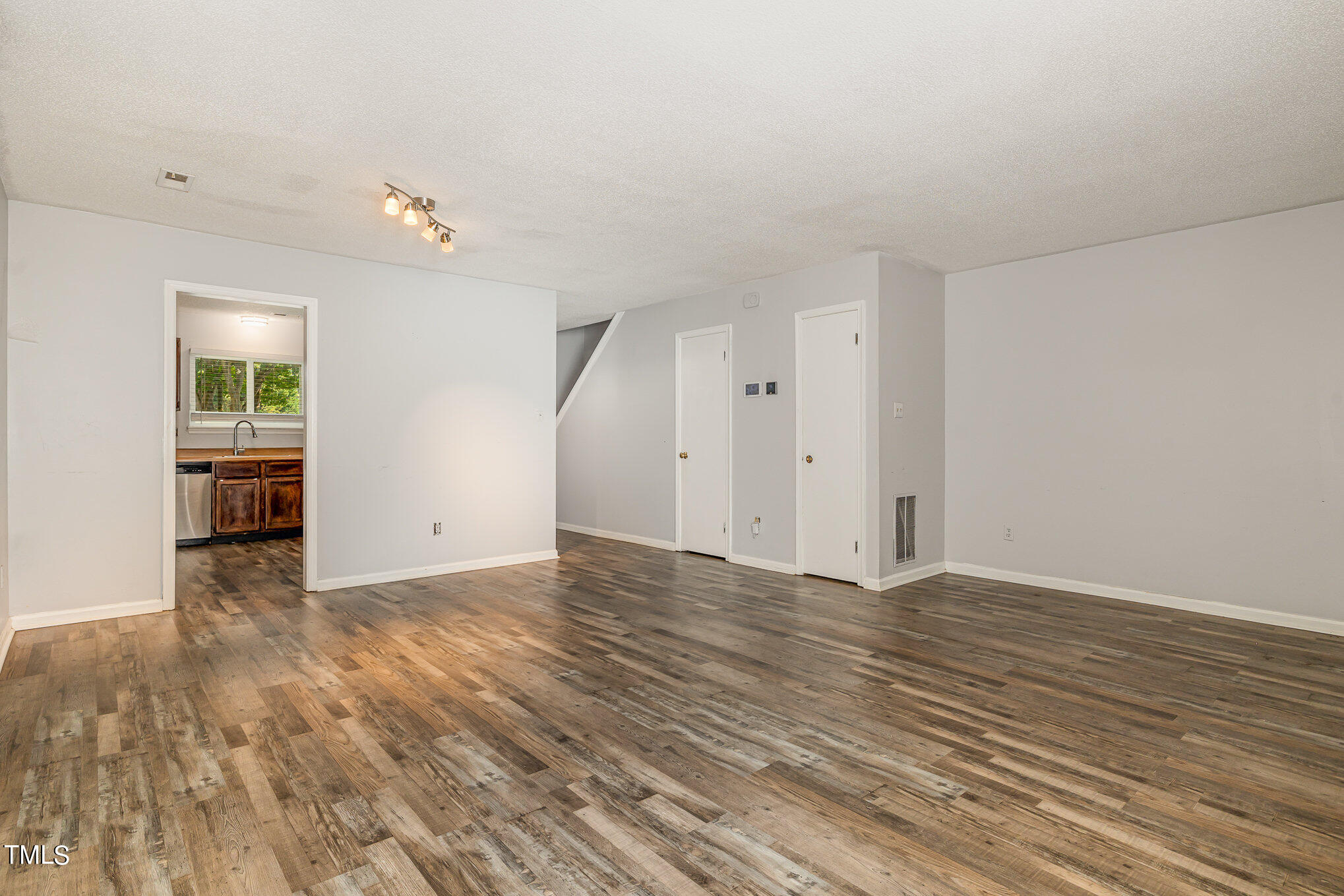 3702 San Pablo Drive Raleigh, NC 27616 - Photo 10 of 26 an empty room with wooden floor and windows