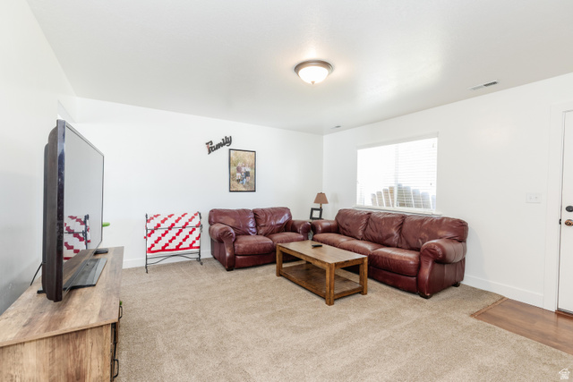1145 West 2640th Street South Logan, UT 84321 - Photo 4 of 17 Carpeted living space with white walls and a ceiling-mounted light fixture