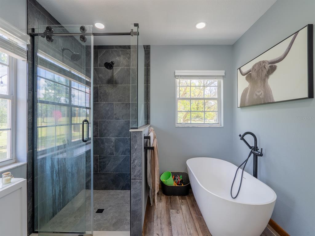 4381 Northeast 105th Place Anthony, FL 32617 - Photo 26 of 49 a bathroom with a bathtub and shower
