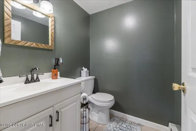 a bathroom with a sink a toilet and mirror