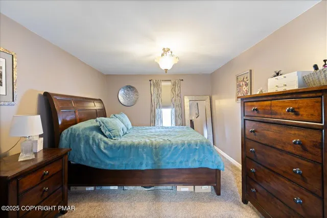 a bedroom with a bed and dresser